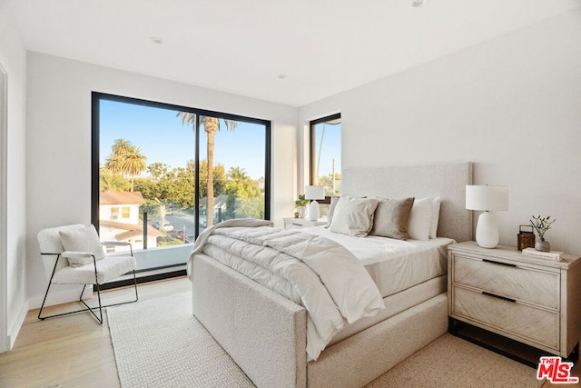 bedroom with light hardwood / wood-style floors