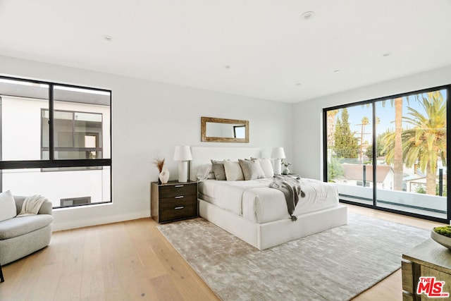 bedroom featuring access to outside and light hardwood / wood-style flooring