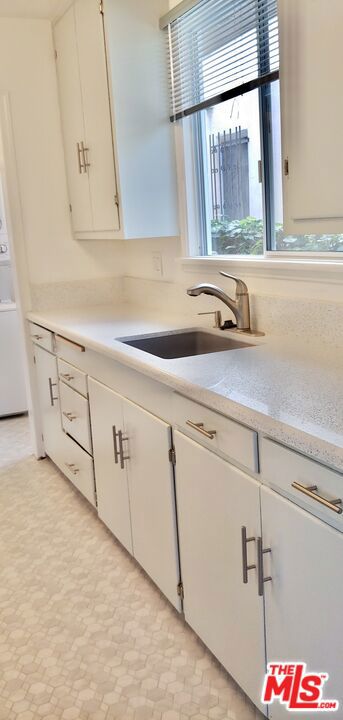 kitchen with sink and white cabinetry