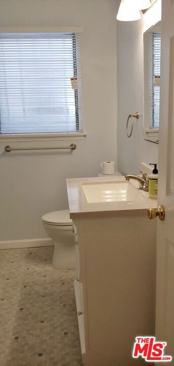 bathroom featuring toilet and vanity