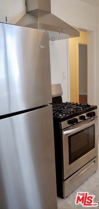 kitchen with wall chimney range hood and stainless steel appliances