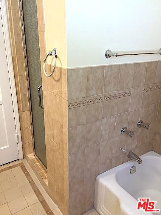 bathroom featuring separate shower and tub and tile patterned floors