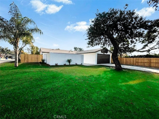 view of front facade featuring a garage, a front lawn, and an outbuilding