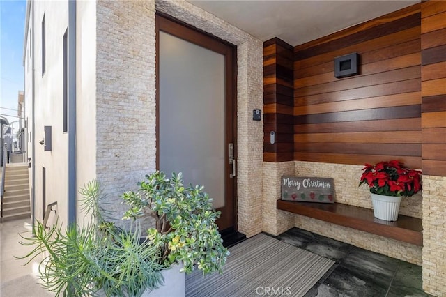 mudroom featuring wooden walls