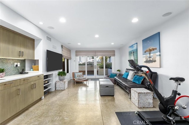 exercise room with recessed lighting, visible vents, and french doors