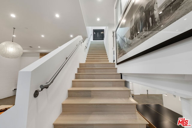 stairway featuring hardwood / wood-style flooring