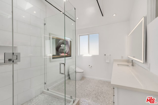 bathroom with toilet, vanity, tile patterned floors, and a shower with door