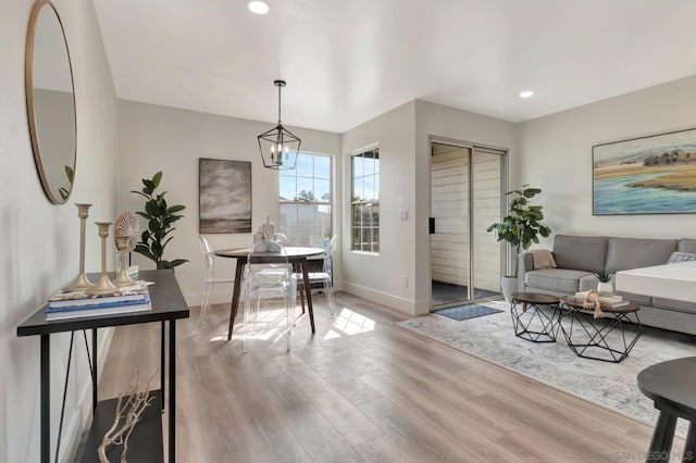 interior space with light hardwood / wood-style floors and a notable chandelier