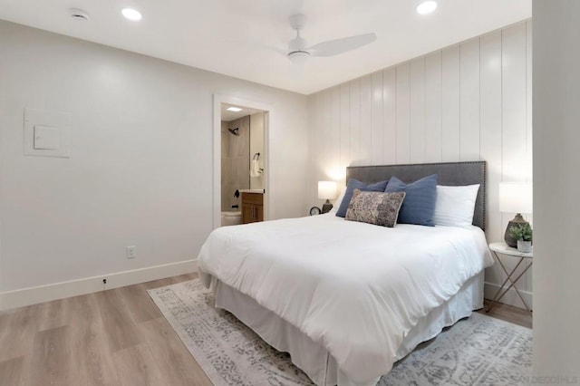 bedroom featuring ceiling fan, light hardwood / wood-style floors, and connected bathroom