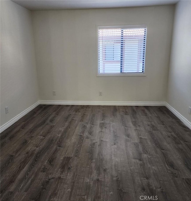 spare room featuring dark hardwood / wood-style flooring