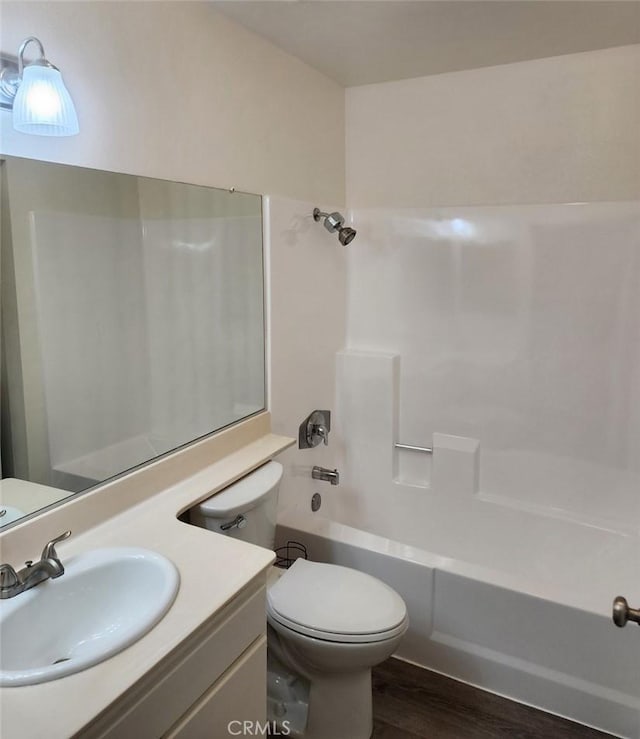 full bathroom with toilet, vanity, shower / bathtub combination, and hardwood / wood-style floors