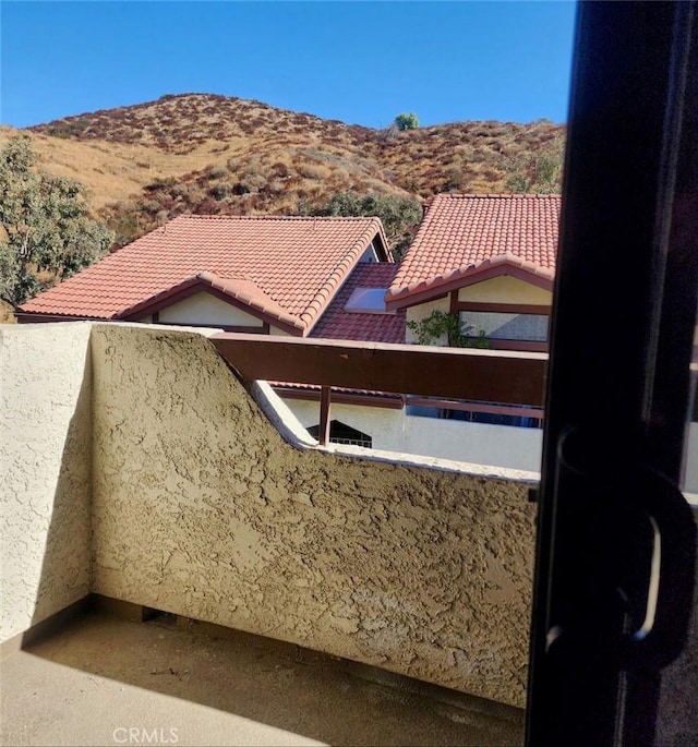 exterior space with a mountain view and a balcony