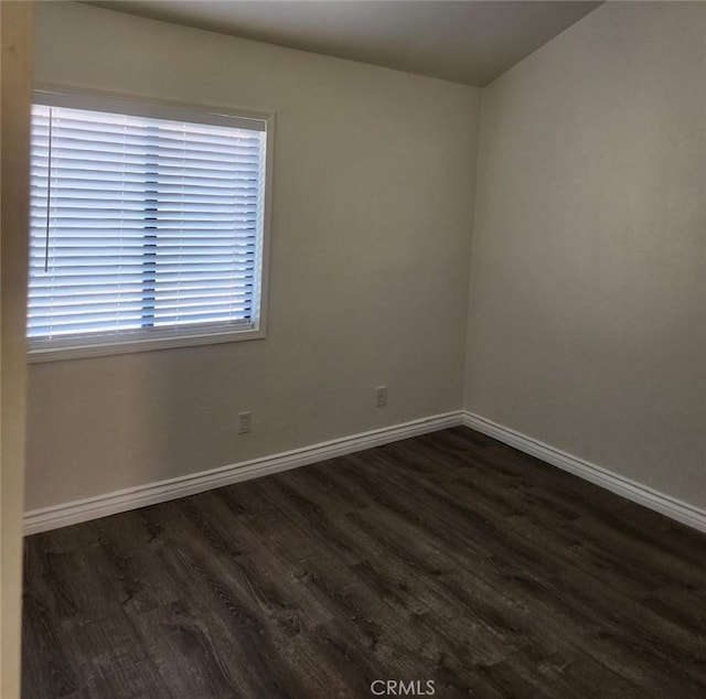 unfurnished room with dark hardwood / wood-style floors