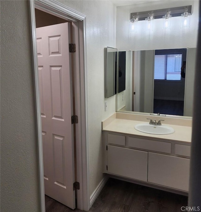 bathroom with hardwood / wood-style floors and vanity