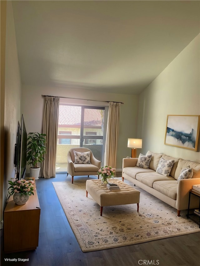 living room with dark hardwood / wood-style floors and vaulted ceiling