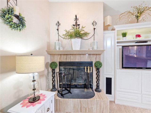 carpeted living room with a tiled fireplace