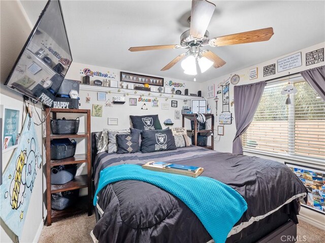 bedroom with ceiling fan and light colored carpet