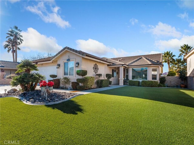 single story home with a front lawn and a garage