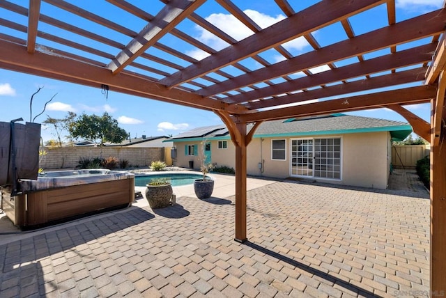 view of patio / terrace with a hot tub and a pergola