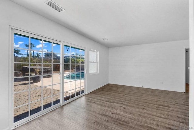 empty room with hardwood / wood-style flooring