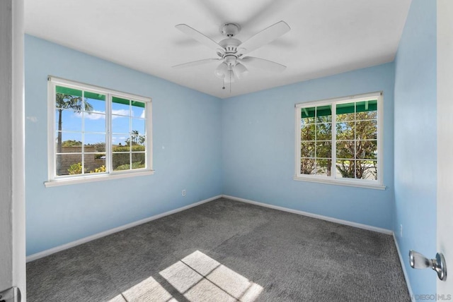 carpeted spare room with ceiling fan