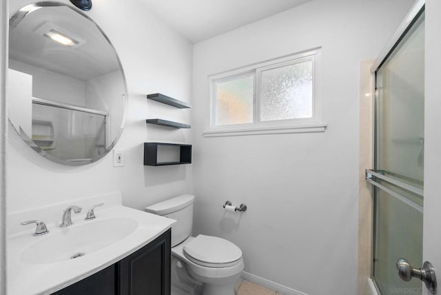 bathroom featuring toilet, vanity, and tile patterned flooring