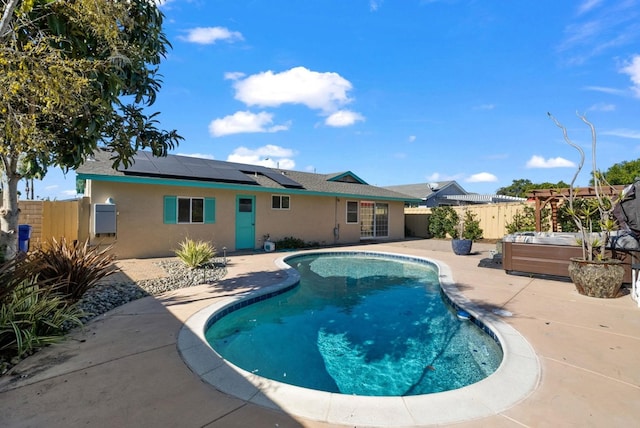 view of pool featuring a jacuzzi and a patio