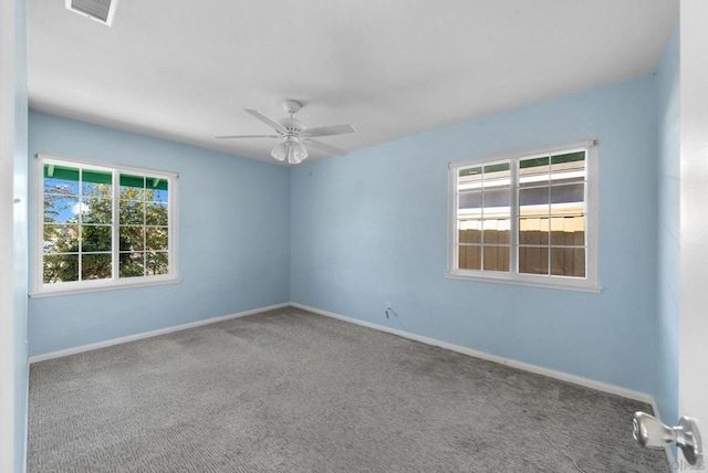 spare room featuring carpet floors and ceiling fan