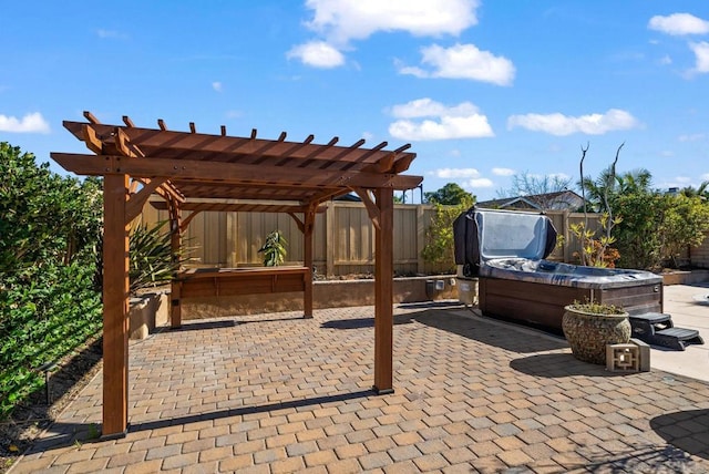 view of patio / terrace featuring a hot tub and a pergola