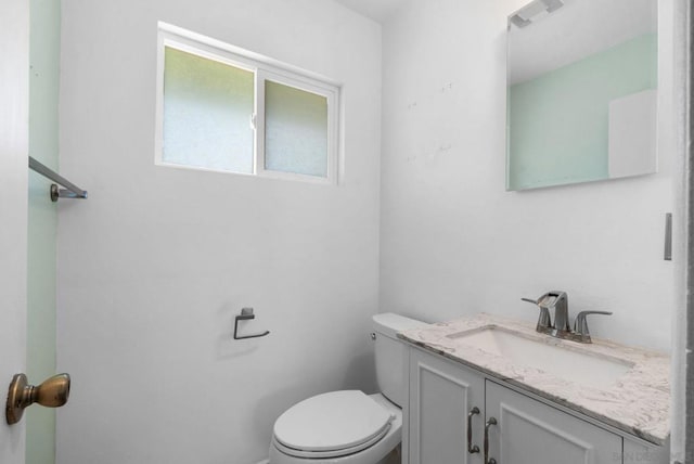 bathroom featuring toilet and vanity