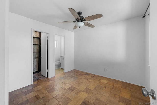 unfurnished bedroom with ensuite bathroom, parquet floors, and ceiling fan