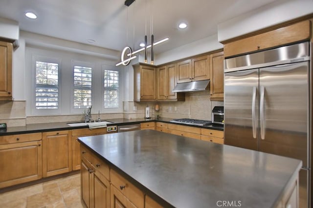 kitchen featuring decorative light fixtures, sink, tasteful backsplash, and stainless steel appliances