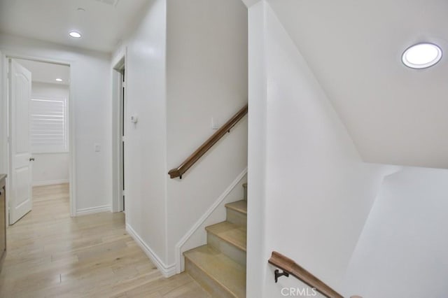 stairway with hardwood / wood-style floors