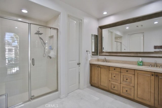 bathroom featuring vanity and an enclosed shower