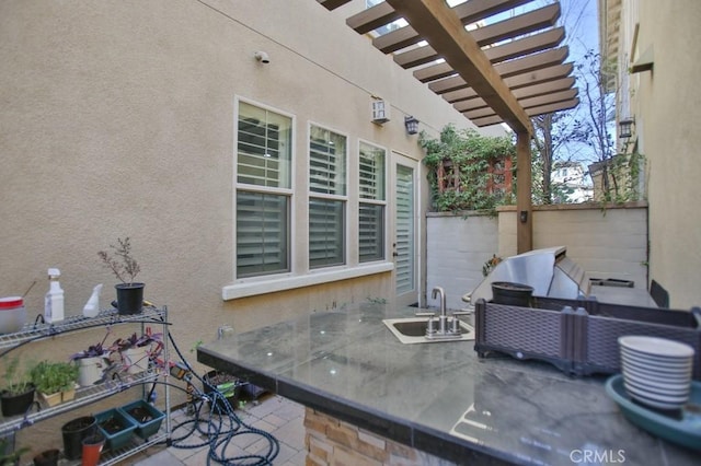 view of patio with a pergola and sink