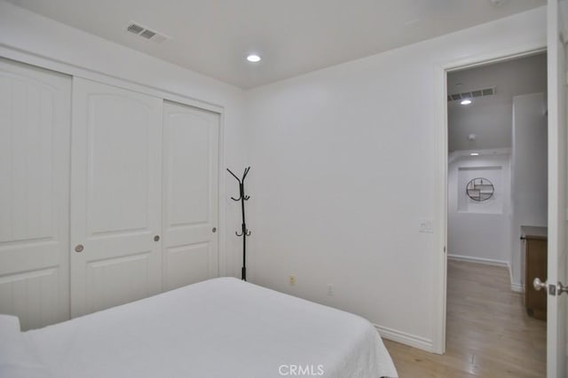 bedroom featuring a closet and light hardwood / wood-style floors