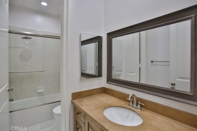 full bathroom featuring toilet, vanity, and enclosed tub / shower combo