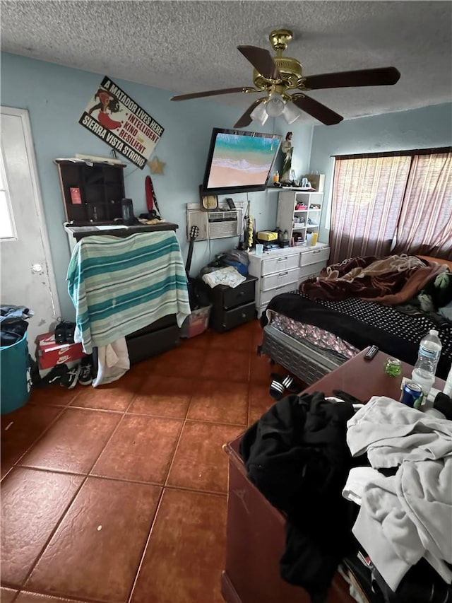 tiled bedroom with ceiling fan and a textured ceiling