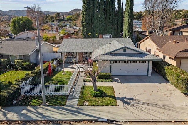 view of front of home with a garage and a mountain view