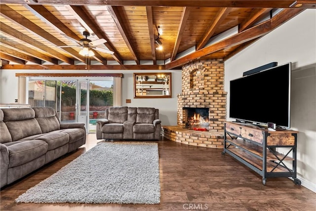 living room featuring ceiling fan, dark hardwood / wood-style floors, a fireplace, beam ceiling, and wooden ceiling