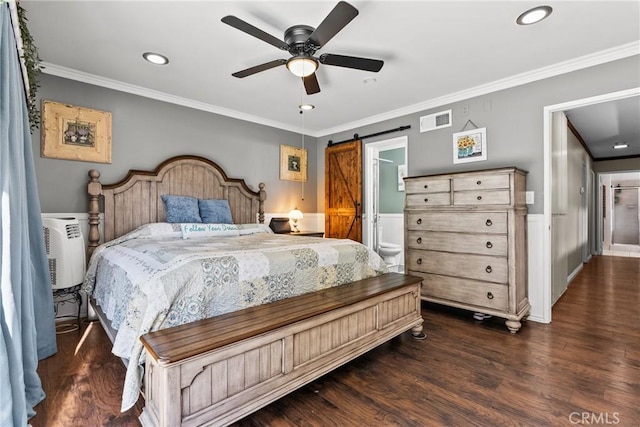 bedroom featuring ceiling fan, a barn door, crown molding, and connected bathroom