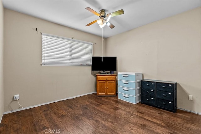 unfurnished office with ceiling fan and dark hardwood / wood-style floors