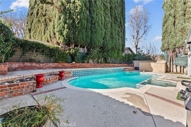 view of pool with a patio and an in ground hot tub