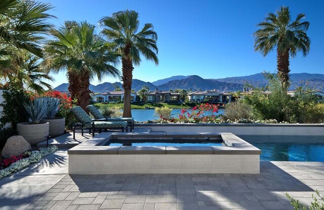 view of pool featuring a mountain view and an in ground hot tub