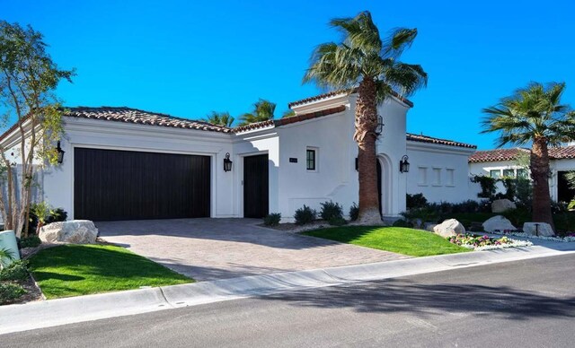 mediterranean / spanish-style home featuring a garage