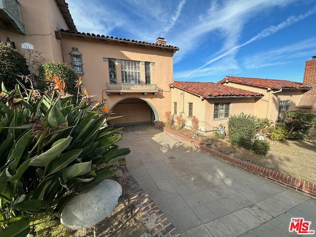 mediterranean / spanish house with a garage