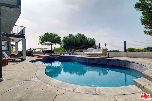 view of pool featuring a patio and an in ground hot tub