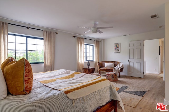 bedroom with ceiling fan and light hardwood / wood-style flooring