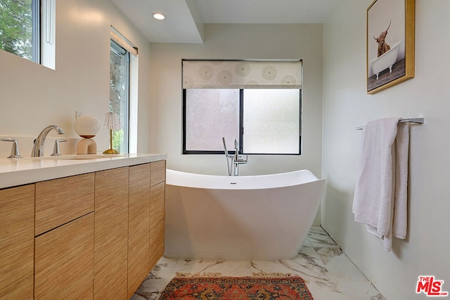 bathroom with vanity and a tub to relax in