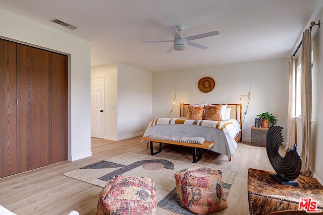 bedroom featuring a closet, ceiling fan, and light hardwood / wood-style floors